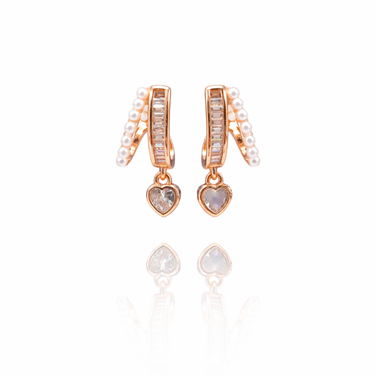 Rose gold plated split hoop earrings with pearl outer row, baguette inner row, and heart pendant drop